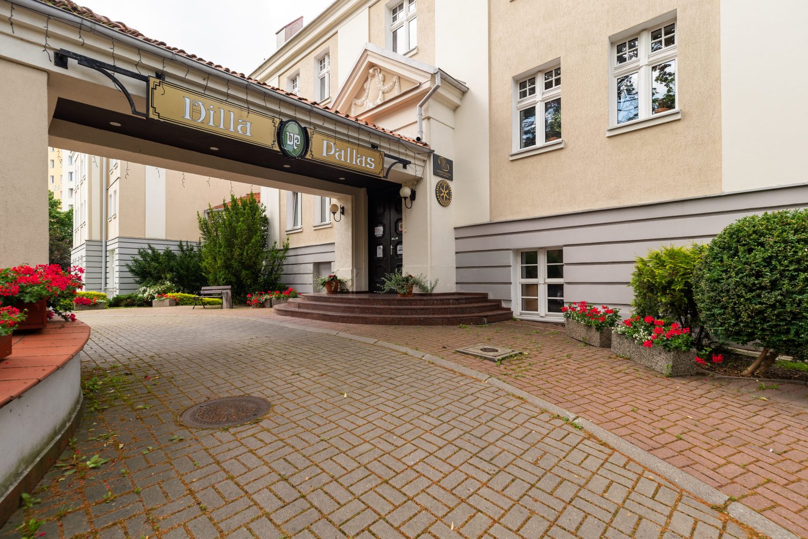 Villa Pallas entrance — brick driveway and sign